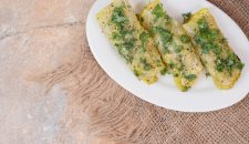 Cabbage dolma rolls on white plate decorated with herbs. High quality photo