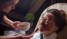 Side vew chocolate mask with woman and master on beauty saloon background