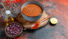 horizontal-view-tomato-soup-blue-bowl-tray-beans-oil-bottle-mixed-color-table