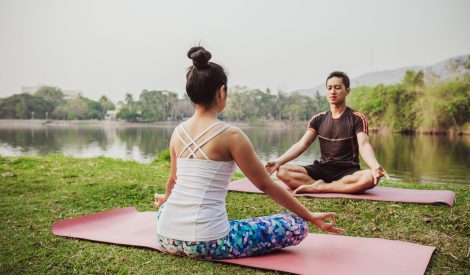 modern-couple-meditating-lake
