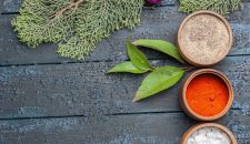top-view-different-seasonings-inside-little-pots-dark-blue-rustic-desk-spicy-edgy-pepper-color